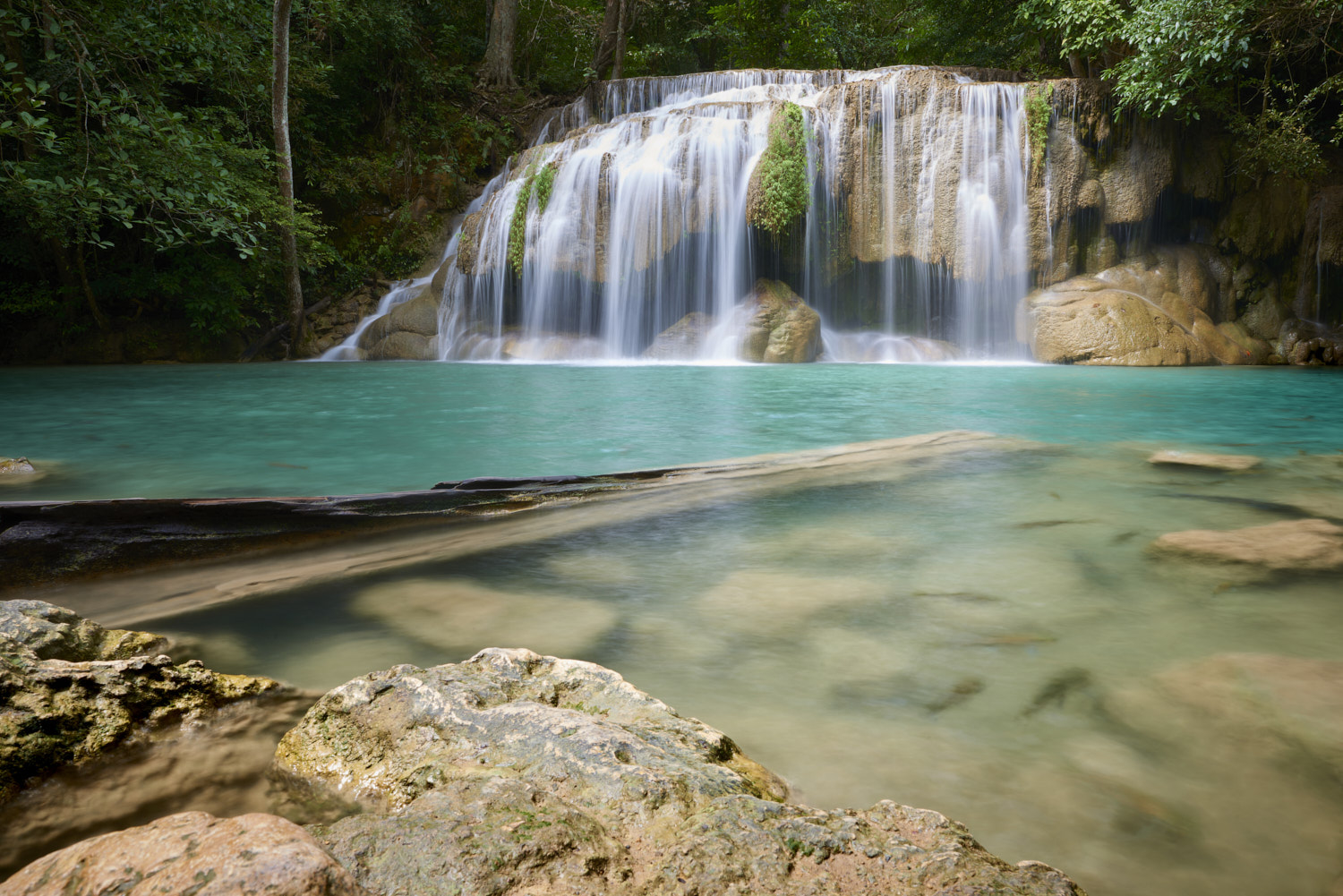 Kanchanaburi, Thailand: Wang Matcha, the second tier of Erawan Waterfall in Kanchanaburi Province, Thailand, with fish swiming in the clear water.